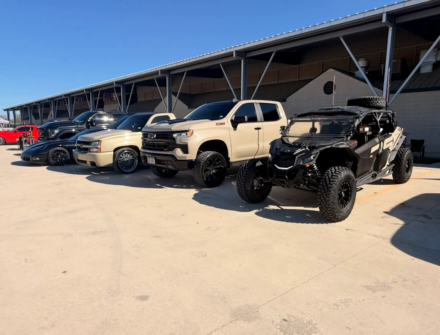 Custom vehicles lined up outside the shop